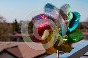 Spinning multicolor pinwheel reflecting sun