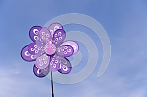 Spinning pinwheel in the shape of a bird, blue sky