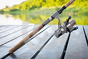 Spinning the rod against the background of the pond professional tool for fishing a predatory fish