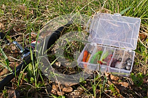 Spinning and set of baits on the grass. Evening fishing.