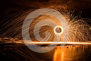 Spinning Steel Wool Sparks Reflecting Pool of Water