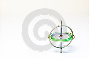 A spinning toy gyroscope isolated on a white background