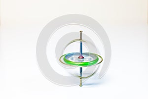 A spinning toy gyroscope isolated on a white background