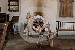 A spinning wheel used for spinning sheeps wool in an old Irish cottage