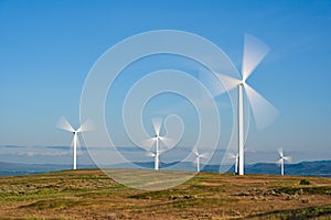 Spinning Wind Turbines against blue sky