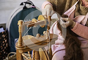 Spinning with a wooden spinning wheel