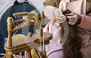 Spinning with a wooden spinning wheel