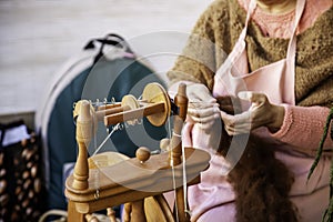 Spinning with a wooden spinning wheel