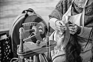 Spinning with a wooden spinning wheel