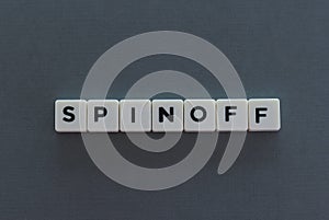 Spinoff word made of square letter word on grey background