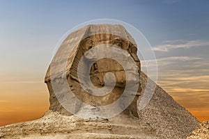 Spinx face on the Giza pyramid background at sunset, Cairo, Egypt