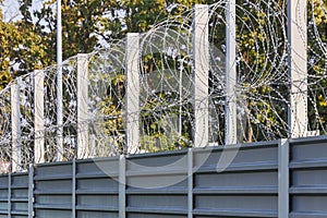 Spiral barbed wire on the fence protects against penetration