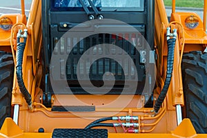 Spiral cable connecting truck cabin and trailer. Pneumatic hoses and electric cables on the coupler of the hitch between a tractor