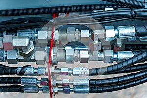 Spiral cable connecting truck cabin and trailer. Pneumatic hoses and electric cables on the coupler of the hitch between a tractor