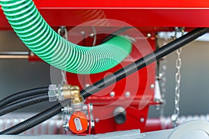 Spiral cable connecting truck cabin and trailer. Pneumatic hoses and electric cables on the coupler of the hitch between a tractor