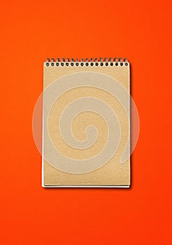 Spiral closed notebook mockup on red background