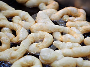 Spiral deep-fried dough stick in Fryer, Patongkoh