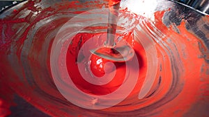 Spiral machine is mingling red-coloured paste