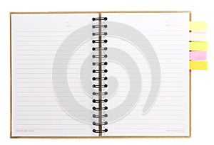 Spiral notebook open on white with colorful note paper