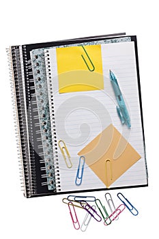 Spiral notebooks with sticky notes paper clips and pen