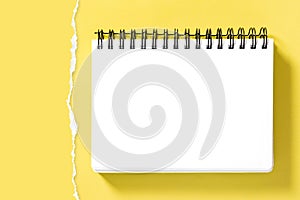 Spiral notepad book mockup torn paper border Yellow background