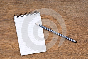 Spiral Notepad and Pencil on a wooden table