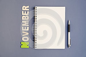 Spiral open notebook with pen and November month wording