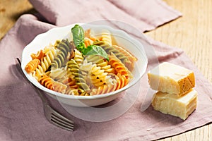 Spiral pasta with cheese on plate