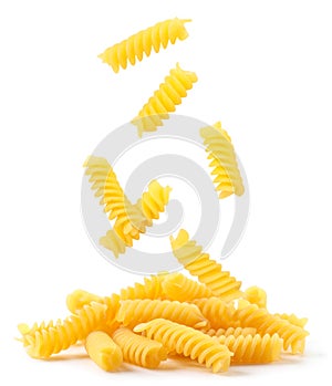 Spiral pasta falling on a heap on a white background. Isolated photo