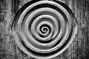 Spiral pattern on textured concrete wall
