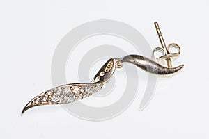 Spiral silver earring with small brilliants