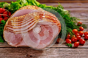 Spiral sliced hickory smoked ham with fresh herb and tomatoes