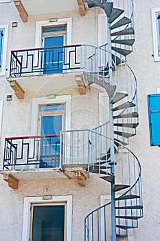 Spiral stair leading to blue doors photo