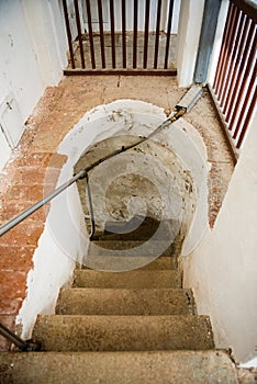 A spiral staircase inside a lighthouse.