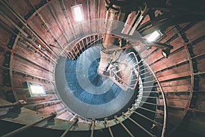 A spiral staircase inside a lighthouse. - vintage film effect