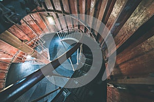 A spiral staircase inside a lighthouse. - vintage film effect