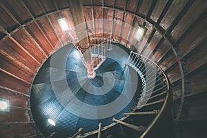 A spiral staircase inside a lighthouse. - vintage film effect