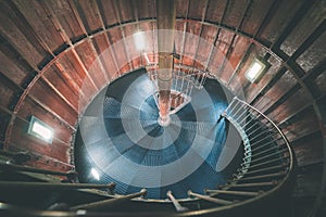 A spiral staircase inside a lighthouse. - vintage film effect