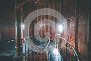 A spiral staircase inside a lighthouse. - vintage film effect