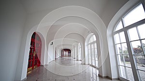 Spiral staircase and long white corridor with doors