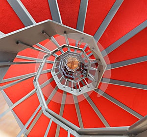 Spiral staircase with red carpet in a building