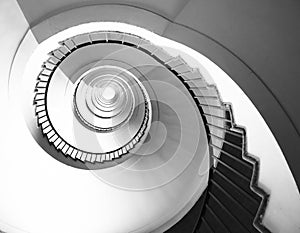 Spiral staircase seen in perspective with the steps going towards infinity