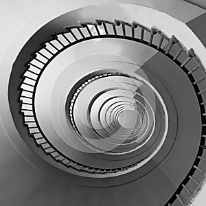 Spiral staircase seen in perspective with the steps going towards infinity