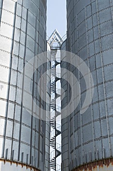 Spiral staircase between steel silos