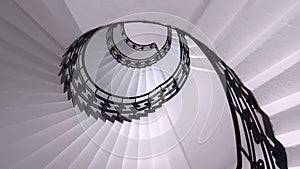 Spiral staircase still life with black ornament railing top view