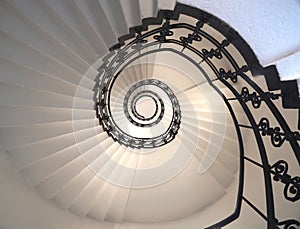 Spiral staircase still life with black ornament railing top view