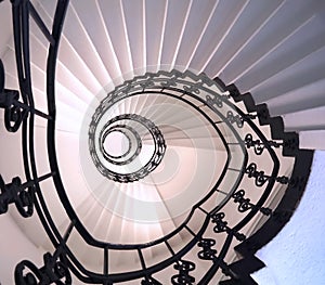 Spiral staircase still life with black ornament railing top view