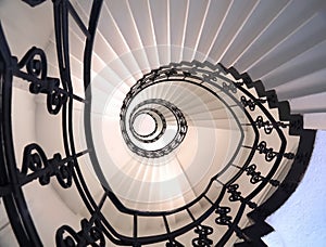 Spiral staircase still life with black ornament railing top view