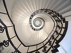 Spiral staircase still life with black ornament railing top view