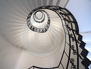 Spiral staircase still life with black ornament railing top view